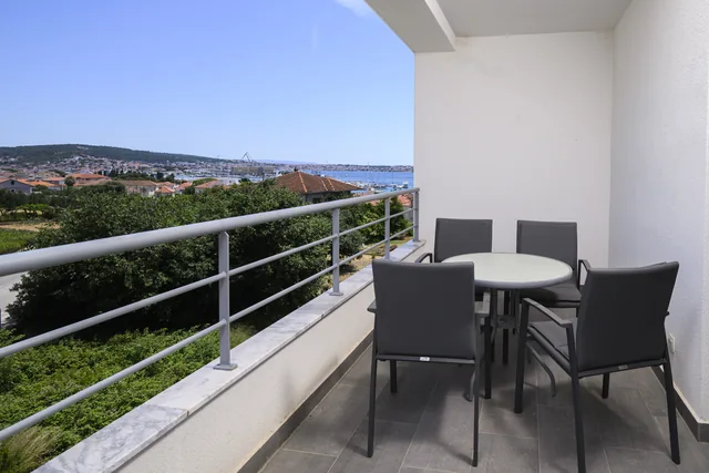 Private balcony with outdoor seating and a dining table