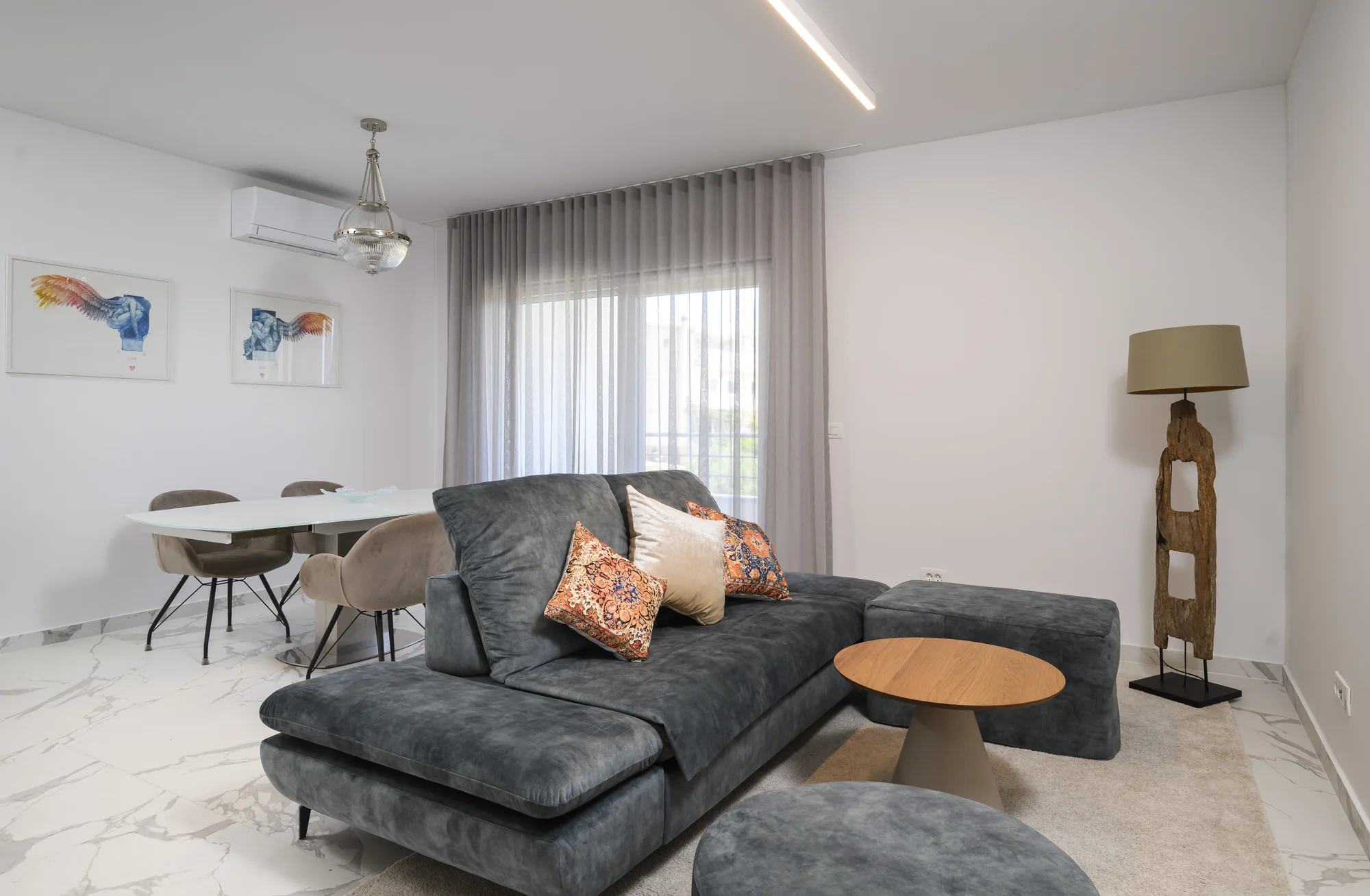Apartment B living room with a corner sofa and dining area