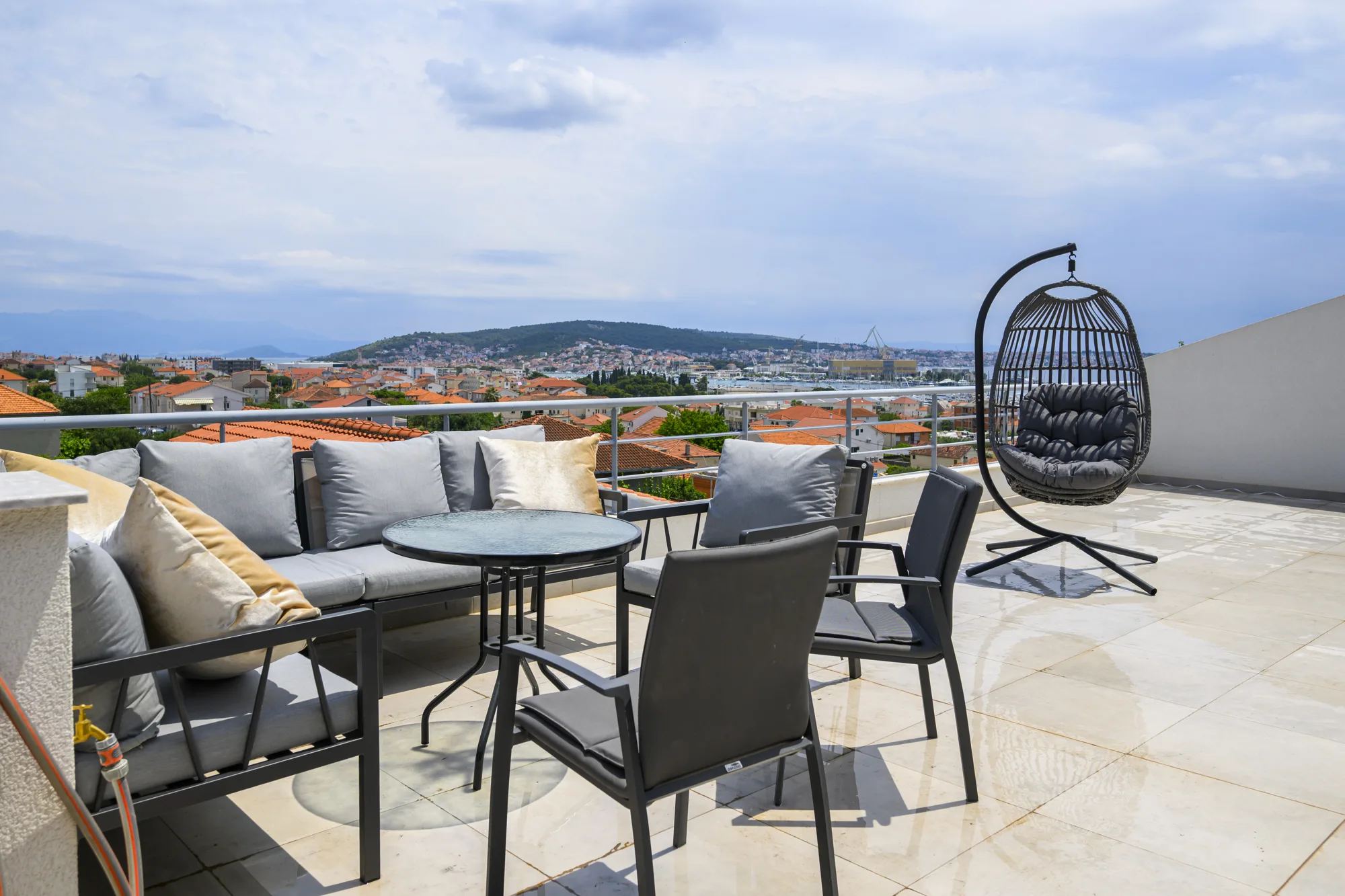 Penthouse terrace with lounge seating and the Adriatic in the distance