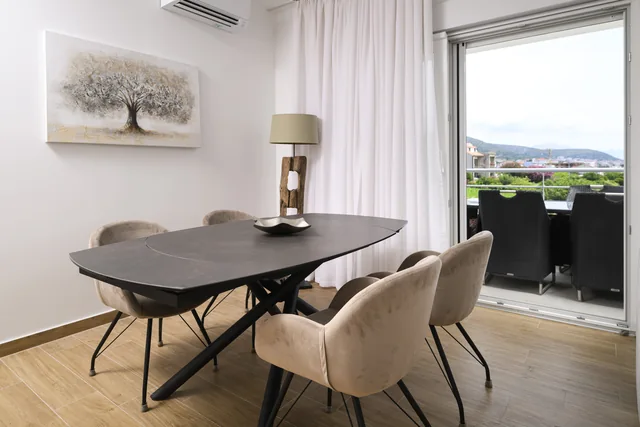 Apartment A dining area opening onto the balcony