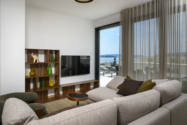 Penthouse living room with terrace doors and a sea view