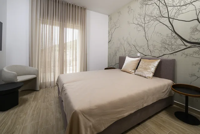 First penthouse bedroom with a tree-patterned feature wall