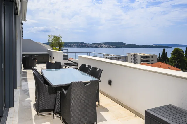 Second terrace with an outdoor dining table and sea views