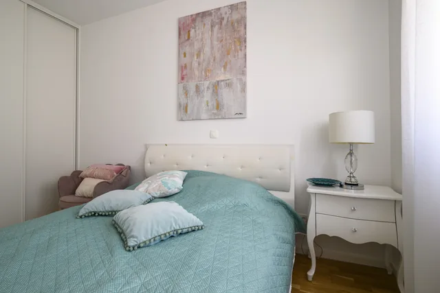 First bedroom with bedside tables and turquoise bedding