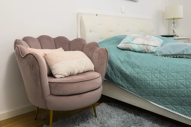 Pink armchair beside the bed