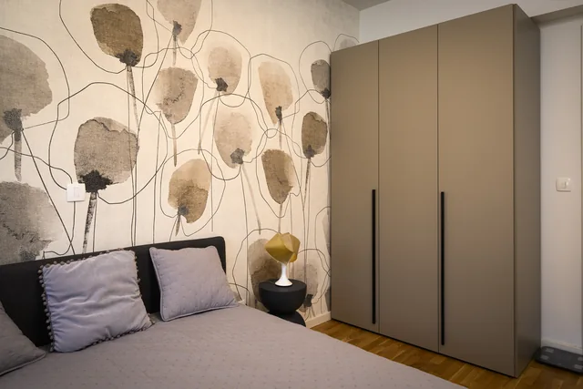 First bedroom with bedside lighting and botanical wallpaper