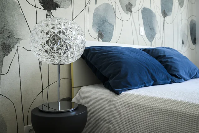 Bedside lamp and blue-accent bedding