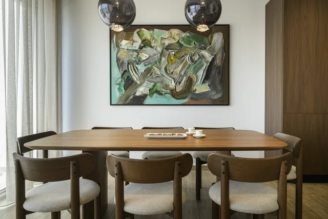 Penthouse dining table beneath pendant lights