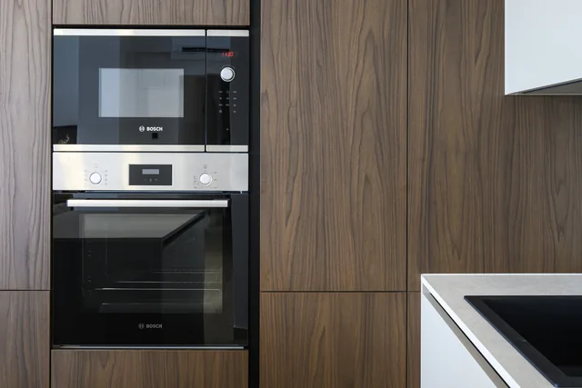 Integrated oven and microwave in wooden cabinetry