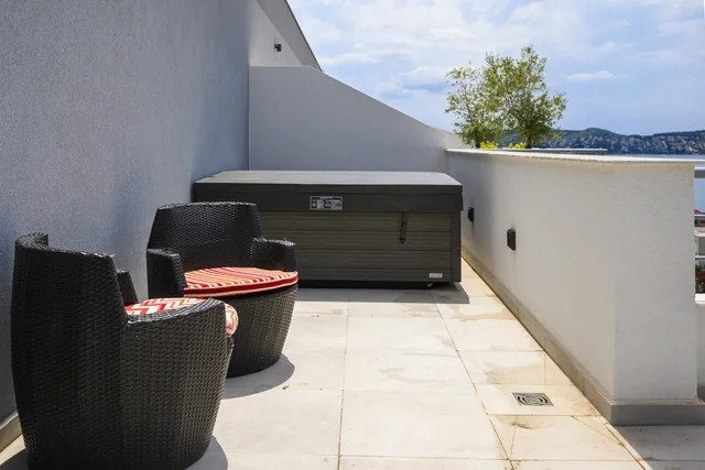 Sheltered terrace seating beside the covered jacuzzi