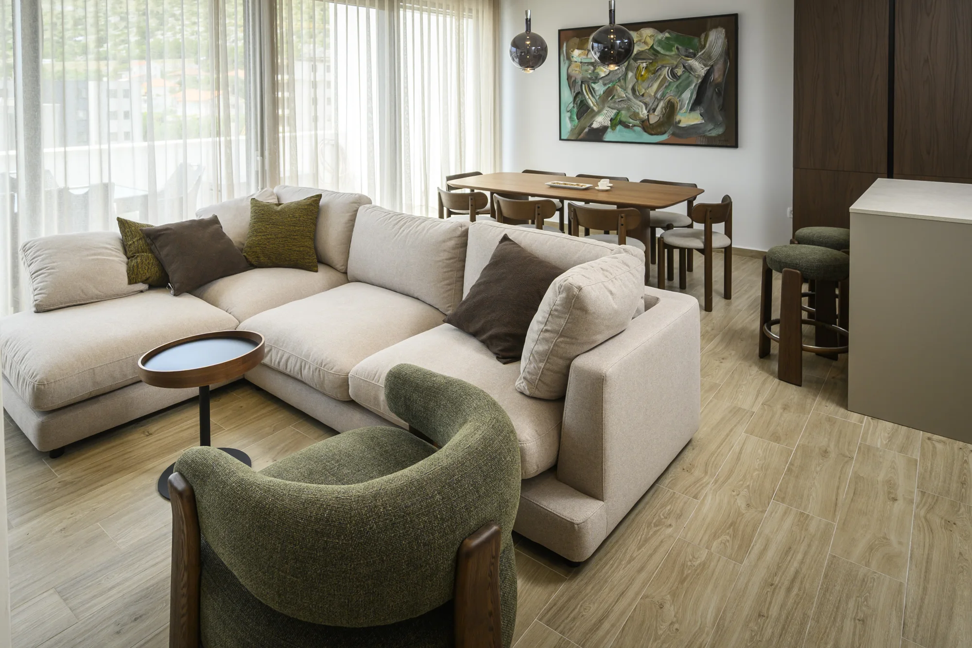 Penthouse living room with natural light and warm wooden furnishings